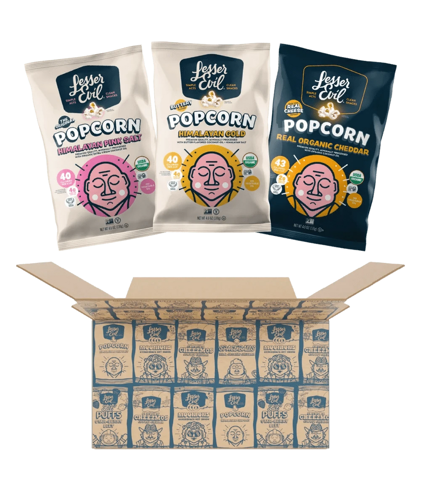 Three bags from the LesserEvil Snacks Popcorn Best Sellers Box—featuring Himalayan Pink Salt, Real Organic Cheddar, and Himalayan Gold popcorn—above an open box of neatly arranged bags.