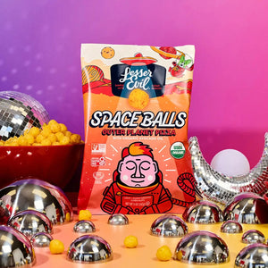 A vibrant scene with a bag of LesserEvil Snacks Flavor-FULL Snacks Box, disco balls, a snack bowl, and a pink-purple gradient background.