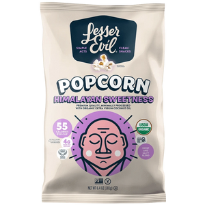 A bag of OrganicPopcorn Himalayan Sweetness Gourmet Popcorn, made with organic cane sugar and Himalayan Pink Salt, in light purple and beige packaging with a cartoon face.