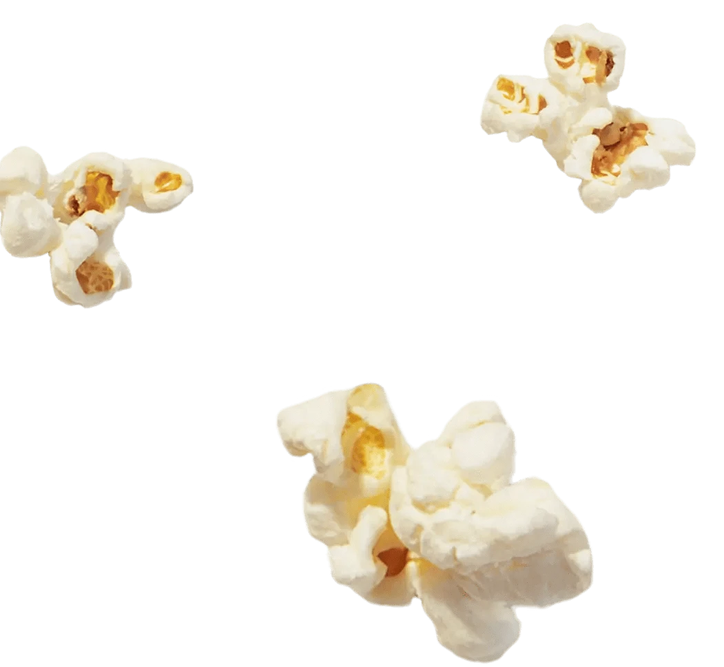 Three pieces of popped popcorn floating separately on a transparent background.