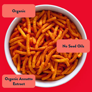 A bowl of Blazin Hot Cheddar Cheezmos by LesserEvil on a red background with labels: Organic, No Seed Oils, Organic Annatto Extract, and clean ingredients.
