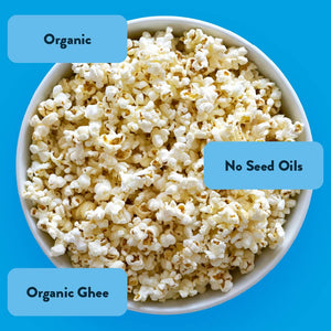 Oh My Ghee! Gourmet Popcorn by OrganicPopcorn shown on a blue background, labeled Organic, Ayurvedic Ghee, and No Seed Oils.