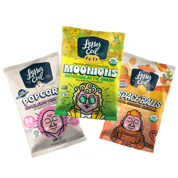 Three colorful snack bags from LesserEvil: Himalayan Pink Salt Popcorn, Intergalactic Onion Moontions, and Real Organic Cheddar Space Balls, each featuring playful cartoon characters.
