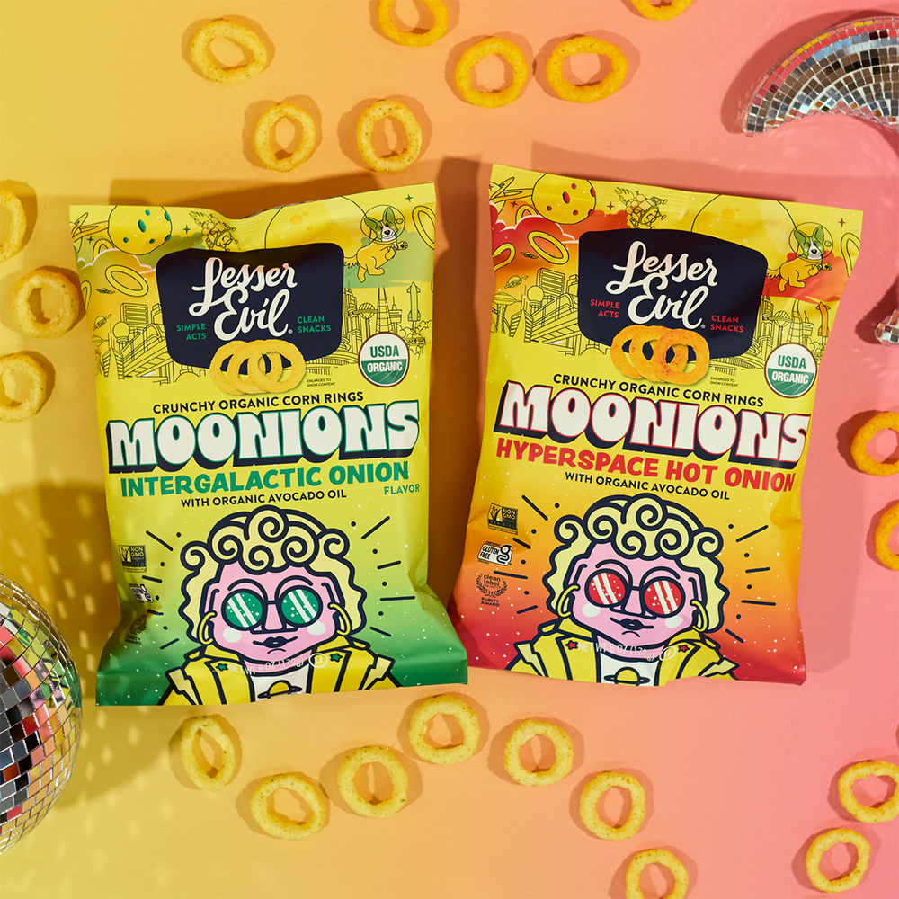 Two colorful bags of Lesser Evil Moonions corn rings, Intergalactic Onion and Hyperspace Hot Onion flavors, on a pastel gradient background with disco balls and snack rings scattered around.