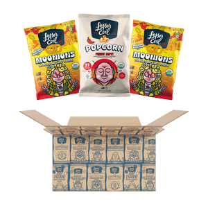 Three bags of LesserEvil Snacks—two Hot Onion Moonions and one Fiery Hot Popcorn—are shown above an open A Little Spice Snacks Box filled with more spicy snacks.