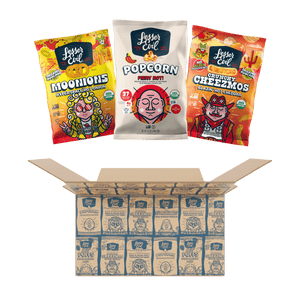 Three colorful LesserEvil Snacks bags are displayed above an open Spicy Snacks Box filled with assorted treats.