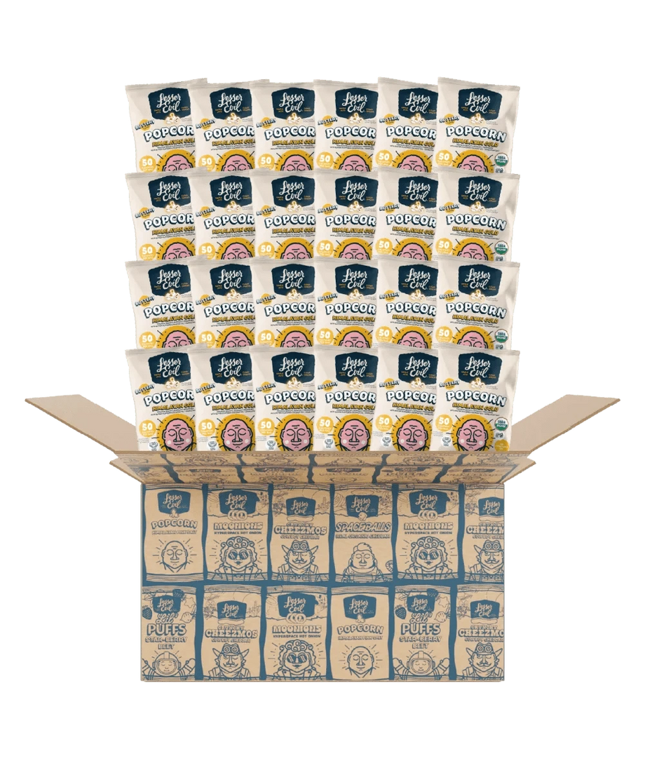 Open cardboard box with multiple snack-sized bags of LesserEvil Snacks Himalayan Gold Organic Popcorn – 24 Pack, in blue and white packaging with popcorn graphics on a green background.