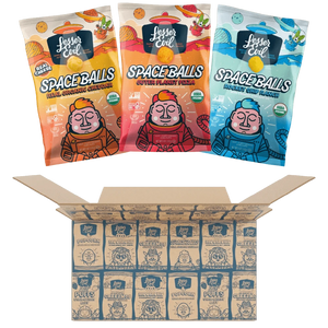 Three colorful bags of Ziggys Stars Space Balls by LesserEvil Snacks are shown above an open box, each with a cartoon astronaut.