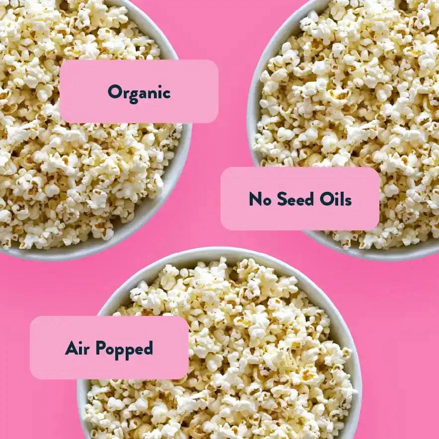 Three bowls of popcorn on pink background labeled: LesserEvil Snacks Popcorn Best Sellers Box, No Seed Oils, and Air Popped.