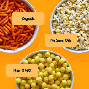 Three bowls from the Cheesy Snack Box by LesserEvil Snacks on an orange background, labeled Organic, No Seed Oils, and Non-GMO.