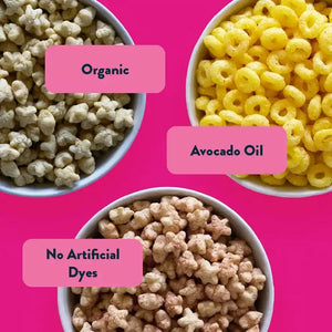 Three bowls of cereal on a pink background, featuring the Lil Favorites Kids Snacks Box by LesserEvil Snacks.
