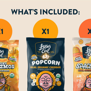 The Cheesy Snack Box by LesserEvil Snacks includes Cheezmos, cheddar popcorn, and Space Balls—each with fun illustrated cheddar-themed organic packaging.