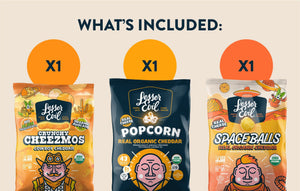 The Cheesy Snack Box by LesserEvil Snacks includes Cheezmos, cheddar popcorn, and Space Balls—each with fun illustrated cheddar-themed organic packaging.