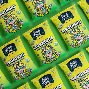 Bags of LesserEvil Intergalactic Onion Moonions snacks are arranged diagonally on a green background, each with a spiral-eyed cartoon character.