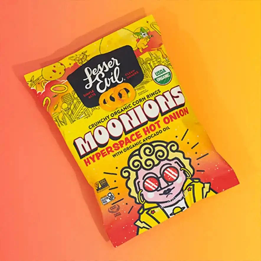 A Little Spice Snacks Box by LesserEvil Snacks features vibrant, space-themed packaging to elevate your snack game on an orange gradient background.