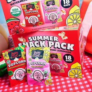LesserEvil Snacks' Summer Popcorn Snack Pack features organic popcorn in watermelon hibiscus & pink lemonade flavors, plus a large box, inflatable watermelon, radio, and red-striped blanket.