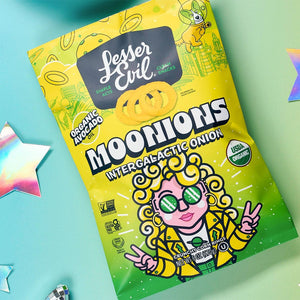 A pastel-colored bag of LesserEvil Intergalactic Onion Moonions features a cartoon, stars, and holographic star stickers.