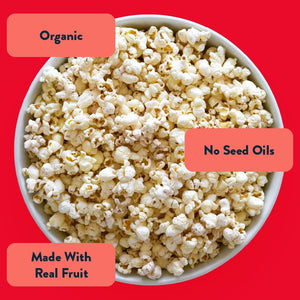LesserEvil Watermelon Hibiscus Popcorn on a red background—Organic, made with real fruit, no seed oils, and bursting with summer flavor.
