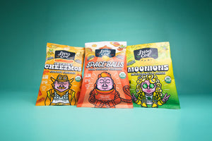 SpaceBalls Real Organic Cheddar Space Balls: a colorful, cartoon astronaut snack bag made with clean ingredients and organic cheddar.