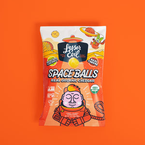 A vibrant bag of SpaceBalls Real Organic Cheddar Space Balls features a cartoon astronaut on an orange, space-themed background and highlights simple, organic ingredients.