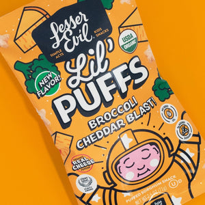 A bag of LesserEvil Broccoli Cheddar Blast Lil Puffs on an orange background, with cartoon broccoli, cheese, and a smiling astronaut on the package.