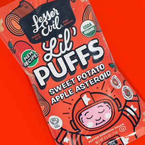 A vibrant bag of LesserEvil Sweet Potato Apple Asteroid Lil Puffs with 0g added sugar, on a red background featuring a cartoon astronaut.