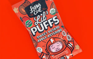 A vibrant bag of LesserEvil Sweet Potato Apple Asteroid Lil Puffs with 0g added sugar, on a red background featuring a cartoon astronaut.