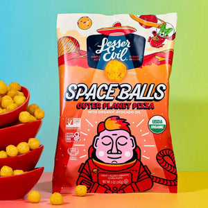 A vibrant bag of SpaceBalls Outer Planet Pizza Space Balls stands beside red bowls of dairy-free cheese balls on a colorful background.