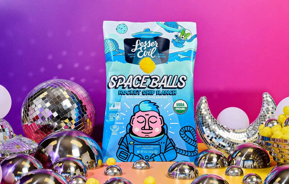 A vibrant bag of SpaceBalls Rocket Ship Ranch Space Balls stands against a disco-ball and crescent-moon background with a pink-orange gradient.
