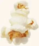 Close-up of a single piece of popped popcorn with white, fluffy edges and a light golden yellow center on a plain background.
